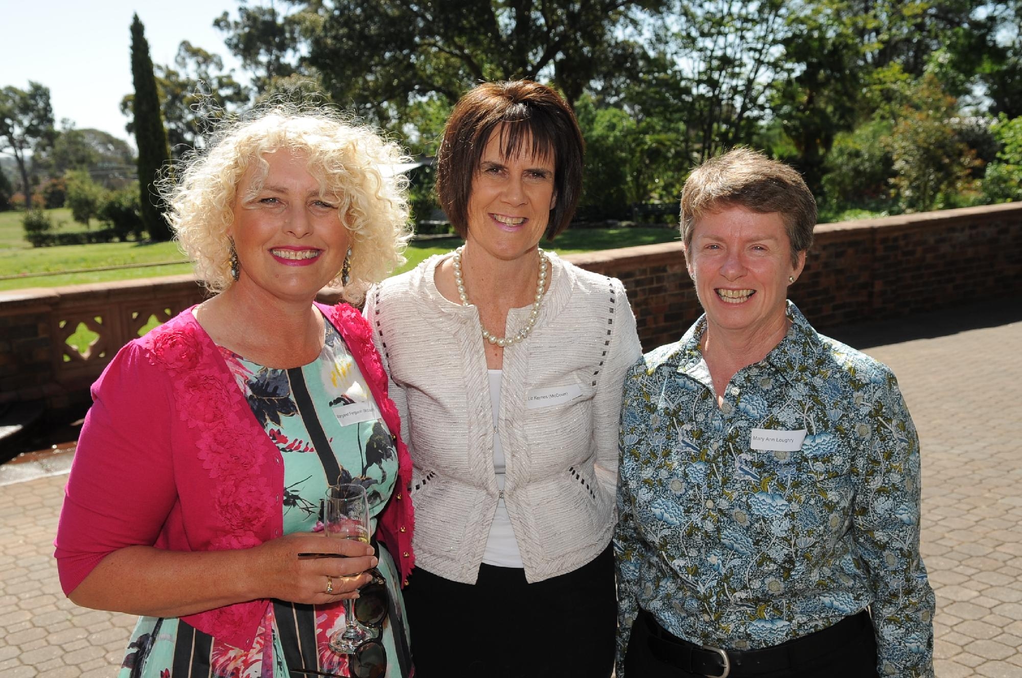 Guests attending a Mercedes College function, posing for a photo in the courtyard.